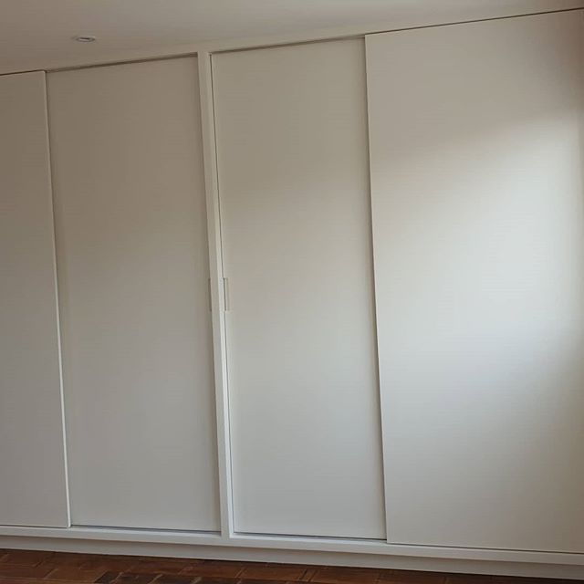 Custom-made wardrobe with sliding doors in London